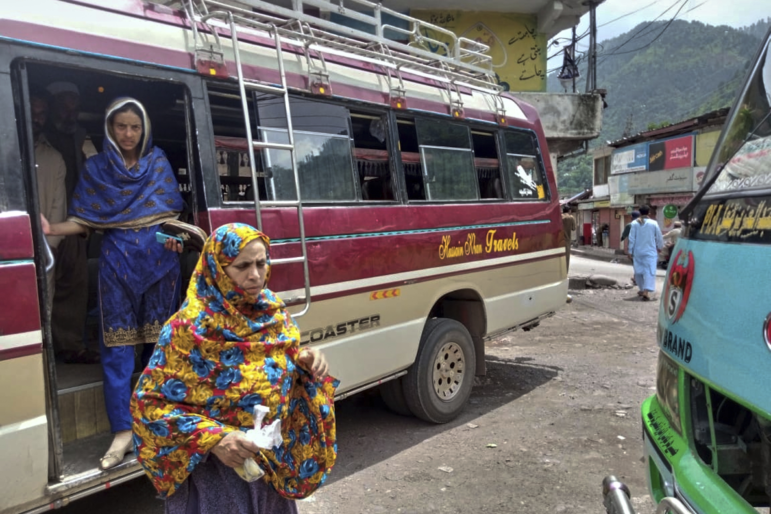 Local residents depart a passenger bus upon their arrival at a bus terminal, day after the ceasefire between Indian and Pakistan was announced, in Chakothi, near Line of Control, some 61 kilometres (38 miles) from Muzaffarabad, the capital of Pakistan controlled Kashmir, Sunday, May 11, 2025.
