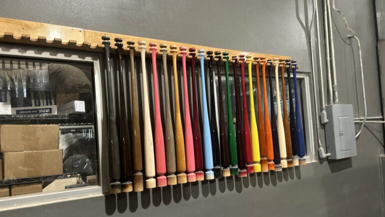 Colorful bats line the walls in Marucci's engraving and finishing room.