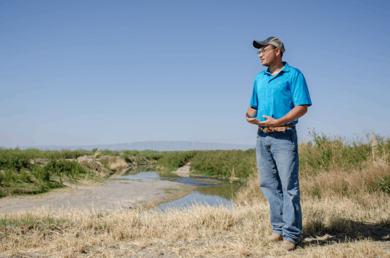 Chris Bell stands near the edge of the Rio Grande in Presidio, Texas. The young farmer is looking to grow alfalfa and turfgrass and help return a once thriving agricultural industry to the region.
