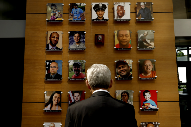 Attorney General Merrick Garland looks at an exhibit titled the Faces of Gun Violence while on a tour led by Steve Dettelbach, director of the Bureau of Alcohol, Tobacco, Firearms and Explosives, at ATF headquarters on April 23, 2024, in Washington, D.C. The display has now been taken down.