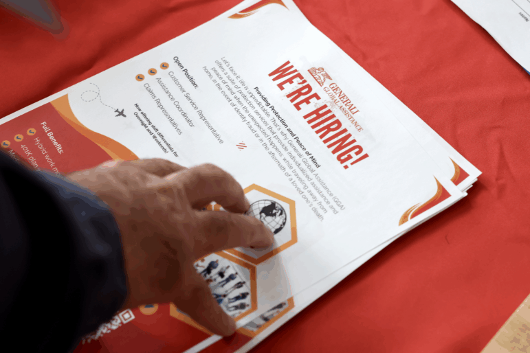 A 'we're hiring' pamphlet at the Mega JobNewsUSA South Florida Job Fair at the Amerant Bank Arena in Sunrise, Fl., on April 30, 2025. Employers continued to add jobs in April, even as President Trump's trade war took a toll on economic growth. The unemployment rate (rose/fell/held steady) from 4.2% the month before.