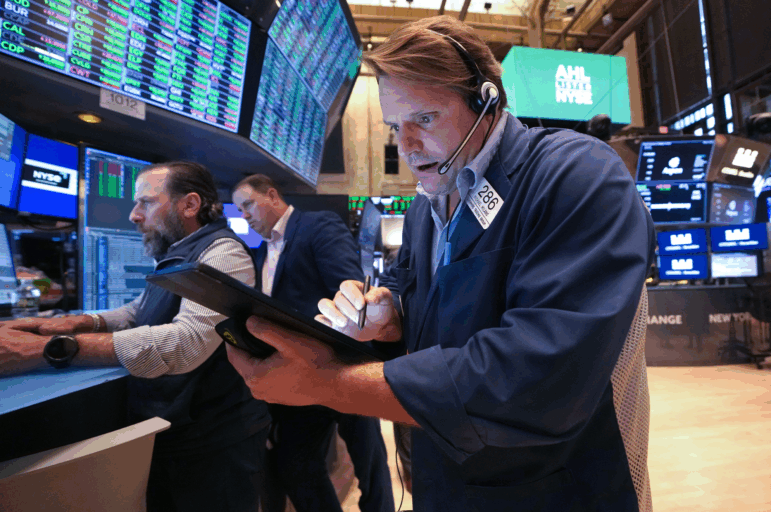 Traders work on the floor of the New York Stock Exchange (NYSE) at the opening bell on May 8, 2025, in New York City.
