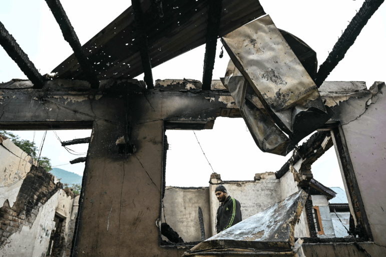 A man stands inside his house destroyed by Pakistani artillery shelling at the Salamabad village in Uri, about 110kms from Srinagar, on May 8, 2025. India's government said on May 8 that Pakistan launched an overnight air attack using "drones and missiles", before New Delhi retaliated to destroy an air defence system in Lahore. "Pakistan attempted to engage a number of military targets ... using drones and missiles," India's defence ministry said in a statement, adding that "these were neutralised" by air defence systems. (Photo by Sajjad HUSSAIN / AFP) (Photo by SAJJAD HUSSAIN/AFP via Getty Images)