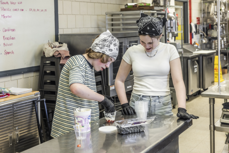 Sixth graders Connor Atkinson and Genevieve Plante work together to make yogurt parfaits in the after-school cooking club in their rural Maine school district.