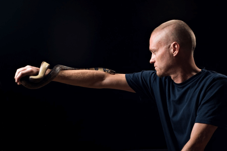 Tim Friede, pictured here with a water cobra, exposed himself to snake venom over decades. Scientists say they have now made a broadly effective antivenom with the help of his antibodies.