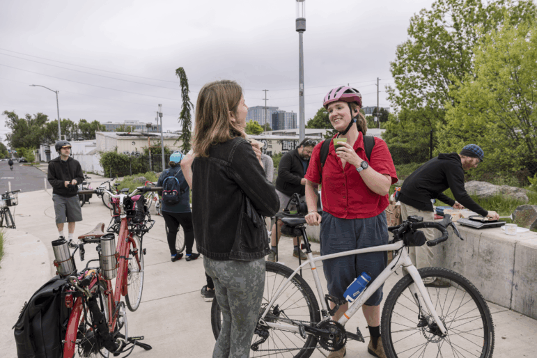 Bicycle commuters stop to grab a cup of coffee and a chat on their way into work as part of Portland's "Breakfast on the Bridges."