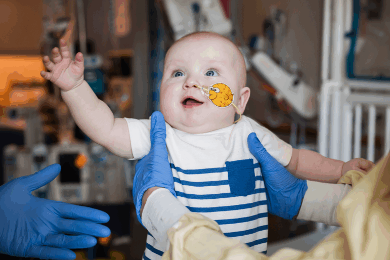 KJ Muldoon, who was born at Children's Hospital of Philadelphia in August, reaches out to the doctors after being treated for a rare genetic disorder using CRISPR technology.