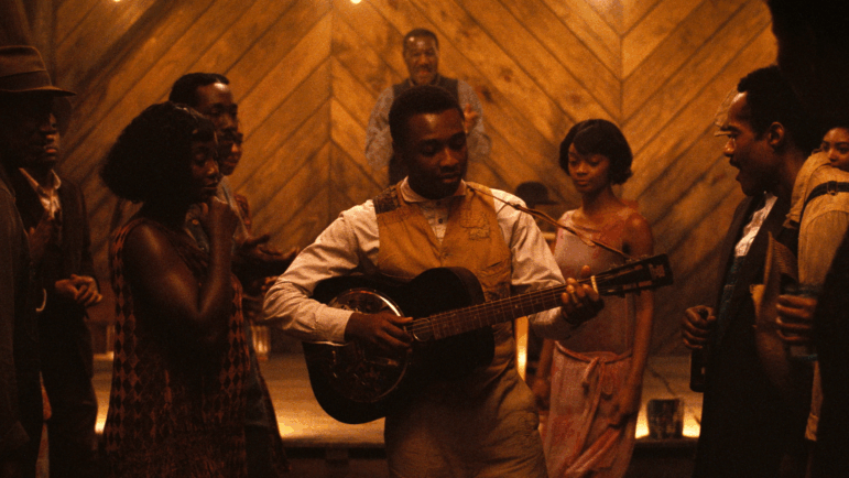 Miles Caton as aspiring bluesman Sammie Moore in a pivotal scene from Sinners.