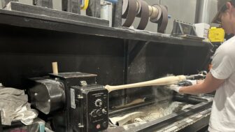 Marucci Sports wood operator Sager Allen sands down a torpedo bat.