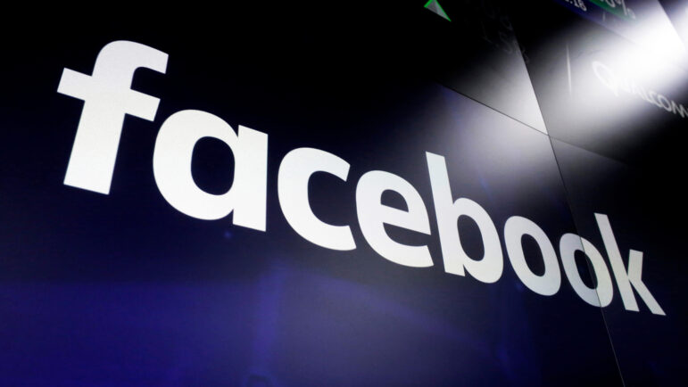 In this file photo, the logo for Facebook appears on screens in New York's Times Square on March 29, 2018.