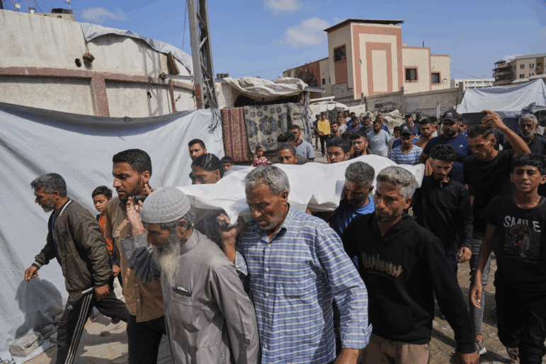 Palestinians carry the body of Reem Al-Akhras who was killed while heading to a Gaza food hub, during her funeral in Khan Younis, southern Gaza Strip, Tuesday, June 3, 2025.