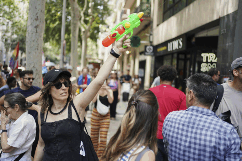 A protester with a water gun takes part in a protest against overtourism in Barcelona, Spain on Sunday.