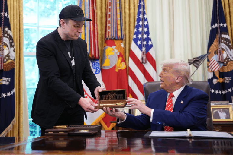 Elon Musk receives a key from President Trump in the Oval Office on May 30, 2025 to thank him for his work with the Department of Government Efficiency. Days later, the pair were feuding online, though Musk has since apologized.