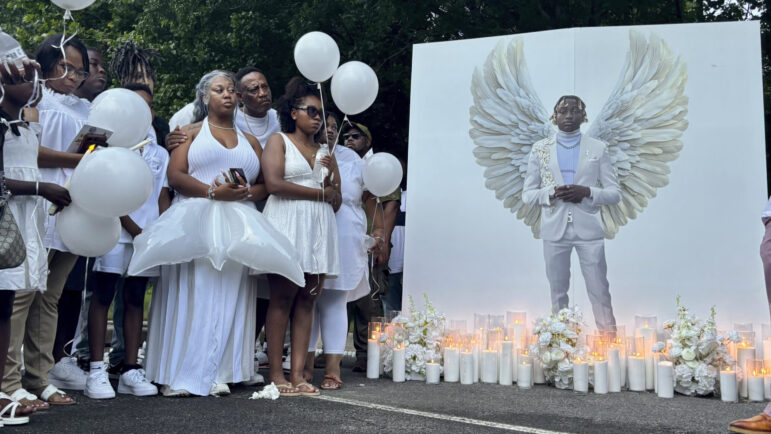 Family members of Jabari Peoples hold balloons at a candlelight vigil in Homewood, Alabama.