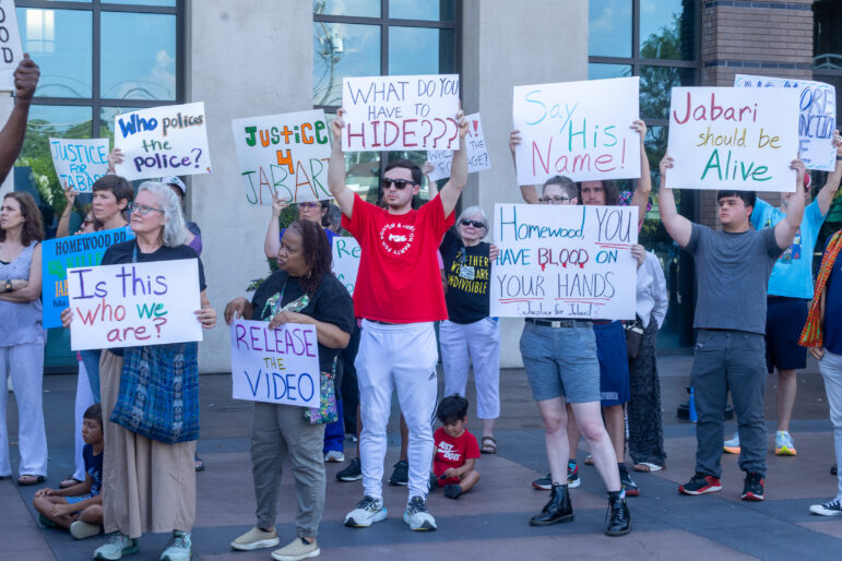 Protestors outside of Homewood City Hall push for the release of body camera footage from the police killing of 18-year-old Jabari Peoples.
