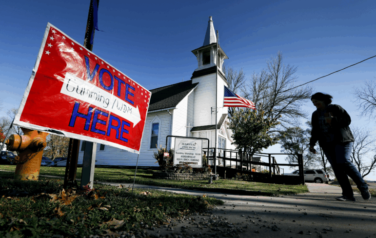 A local resident leaves a church after voting in an l election in Cumming, Iowa.