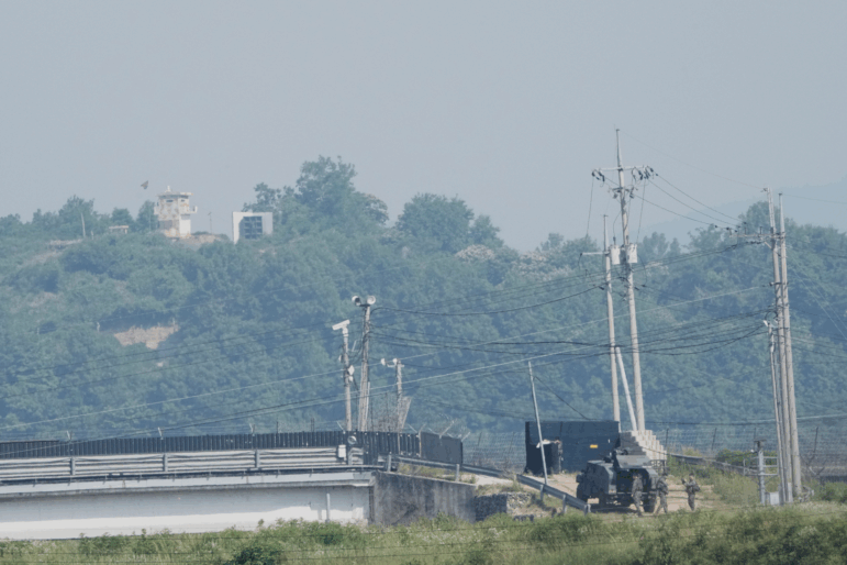 A North Korean military guard post, loudspeaker, top left, and South Korean army soldiers, bottom right, are seen from Paju, South Korea, near the border with North Korea, on June 12.