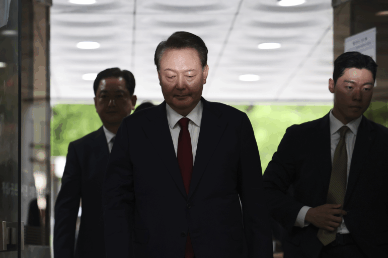 Former South Korean President Yoon Suk Yeol, centerm arrives at a court to attend a hearing to review his arrest warrant requested by special prosecutors in Seoul, South Korea Wednesday, July 9, 2025.