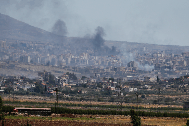 Smoke rise from clashes between Syrian government forces and Druze militias in Sweida city, southern Syria on Tuesday.