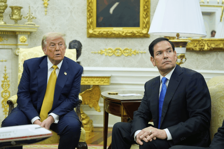President Trump and Secretary of State Marco Rubio listen during an Oval Office meeting at the White House on July 16.