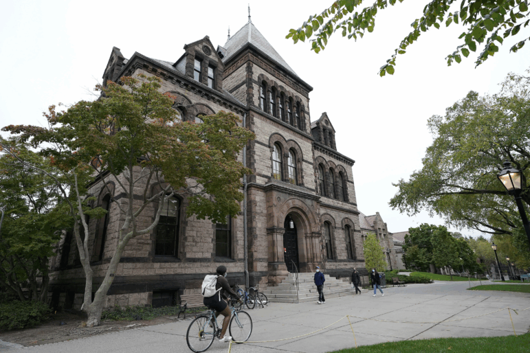 People are seen traversing the Brown University campus in Providence, R.I., Oct. 12, 2020.