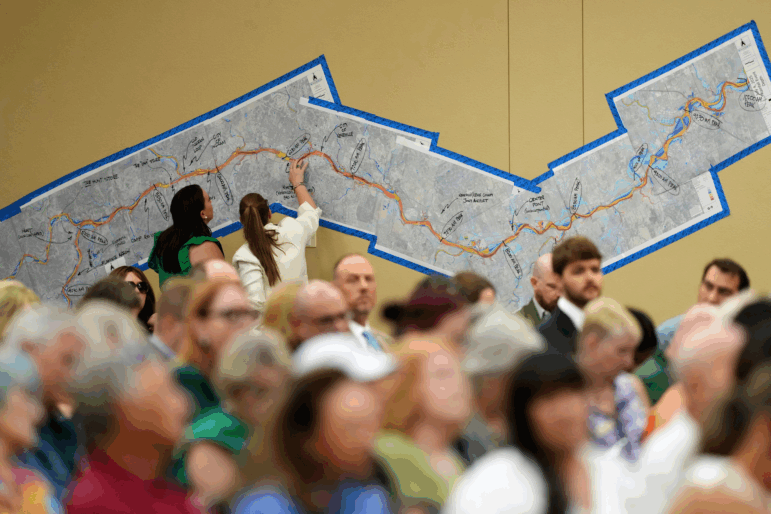 Attendees look at a marked up map of the Guadalupe River during a public hearing in Kerrville, Texas.