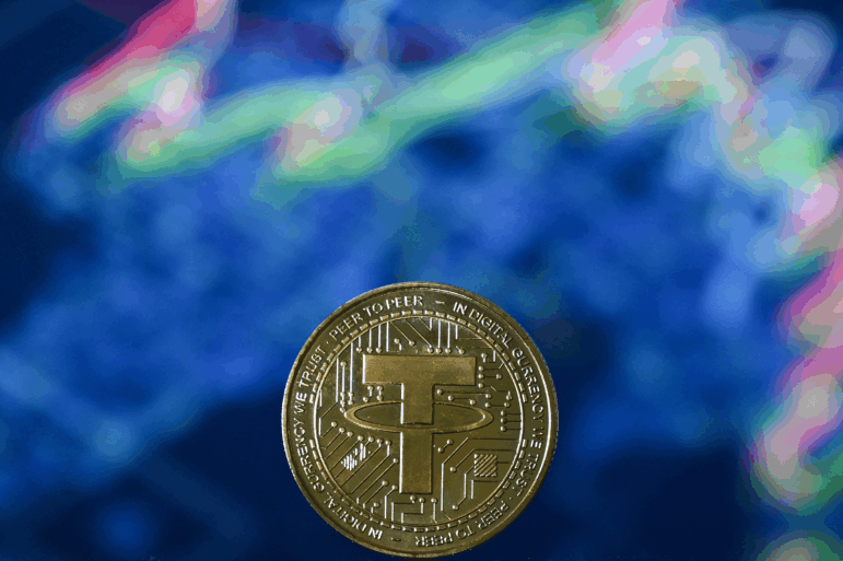 A picture taken in London shows a gold-plated souvenir stablecoin issued by Tether.