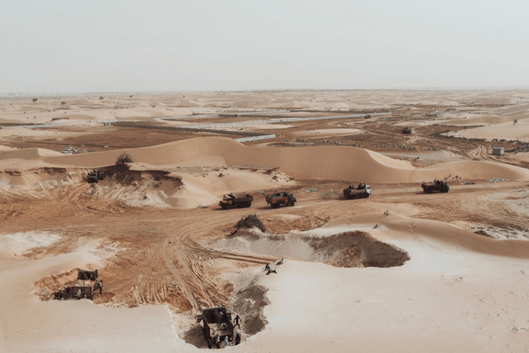 This aerial view show trucks loading sand from a quarry on the outskirts of Nouakchott, Mauritania,on March 14, 2023.