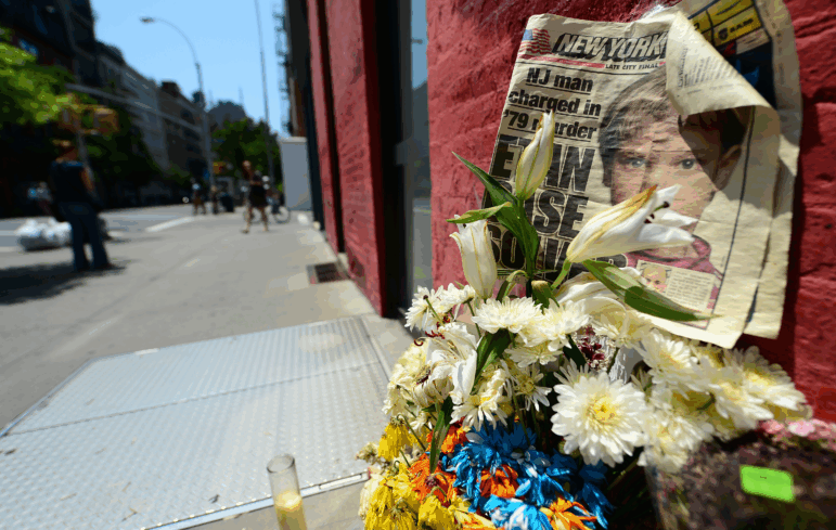 People walk past a street shrine to six-year-old Etan Patz.