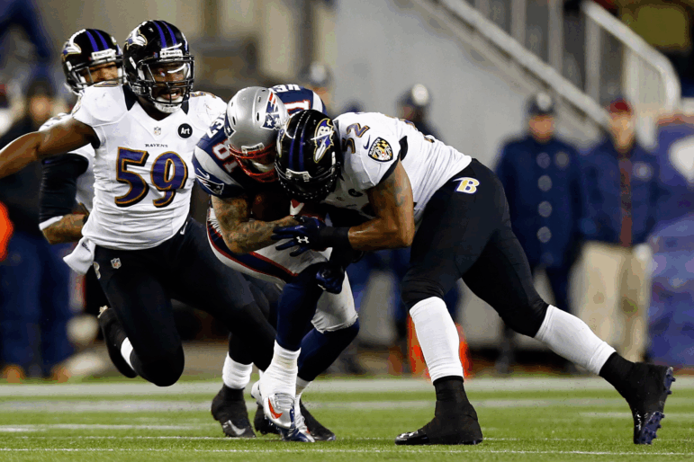 Aaron Hernandez of the New England Patriots gets tackled with his helmet by Ray Lewis of the Baltimore Ravens during the 2013 AFC Championship game at Gillette Stadium on Jan. 20, 2013, in Foxboro, Mass. Hernandez died by suicide in 2017, and researchers found he had a severe case of CTE.