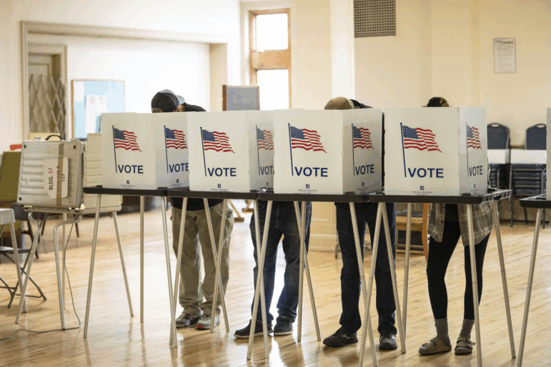 Voters cast 2024 general election ballots in Detroit. A review by the Michigan secretary of state found 16 credible cases of noncitizen voting in Michigan in that election — out of 5.7 million votes cast.