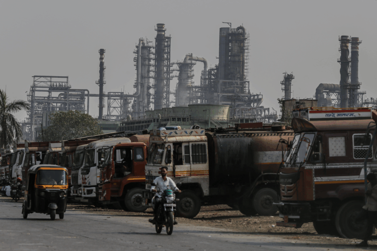 Oil tanker trucks sit outside an oil refinery operated by Bharat Petroleum Corp. Ltd., in Mumbai, India.