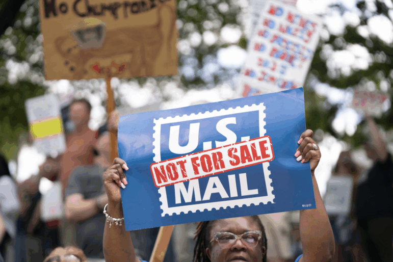 A demonstrator holds a sign that says “U.S. MAIL NOT FOR SALE” during an April protest in Columbia, S.C.