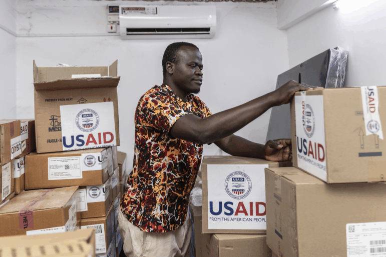 KISUMU, KENYA - APRIL 24: Pharmacist Joseph Njer Airo inspects boxes of antiretroviral drugs labeled "USAID," from the last donation before the funding cuts inside the medical stockroom of Migosi Sub-county Hospital on April 24, 2025 in Kisumu, Kenya.Kisumu has one of the highest HIV rates in Kenya, with around 17.6% of the adult population are living with the virus, nearly five times the national average of 4.5%. In 2025, Kisumu has become a focal point of a growing healthcare crisis, as funding cuts from the United States Agency for International Development (USAID) ripple through the local health system. USAID sent KES 84.1 billion (around USD 600 million) to Kenya to support a range of sectors, including health, education, and economic development. KES 18.8 billion was allocated to HIV/AIDS programs, which served as a critical lifeline for high-burden regions like Kisumu. What appeared at first to be a bureaucratic adjustment as Donald Trump became president has translated to severe disruption of life-saving services. Clinics are shutting down, access to essential medicines is diminishing, and some mothers have been forced to ration antiretroviral treatments (ARVS), risking both their health and that of their children. Thousands of lives now hang in the balance, and without urgent, sustained intervention, the progress made in HIV prevention and treatment over the past two decades risks being rapidly undone.