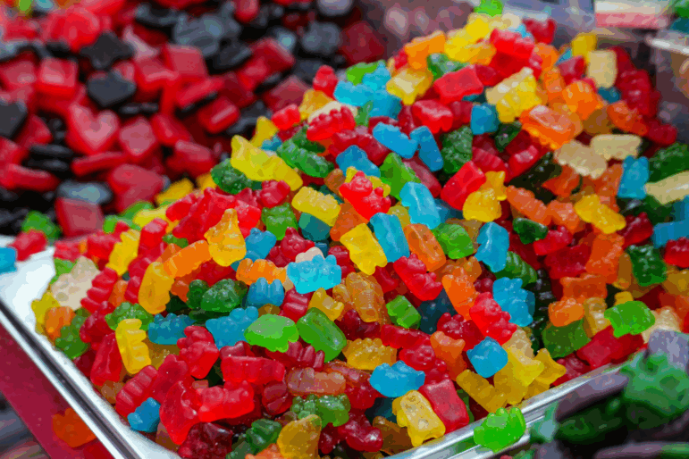 A tray of colorful Gummy Bears and candy.
