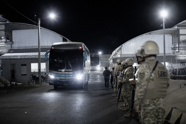 Venezuelan migrants accused by the U.S. of belonging to the Tren de Aragua criminal gang are seen being transferred from the Terrorism Confinement Center (Cecot) in El Salvador before being repatriated to Caracas on July 18, 2025 in La Paz, El Salvador.