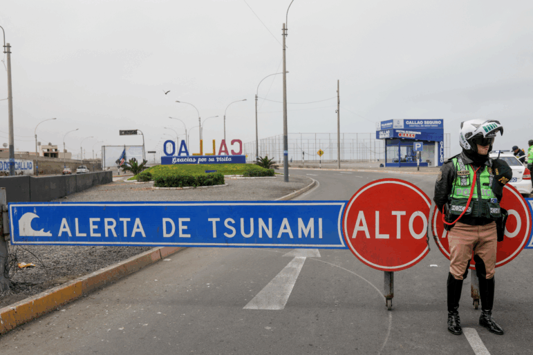 A traffic police officer in Peru sets up a roadblock during a tsunami warning in La Punta, Callao province on July 30, 2025. Alerts were issued in countries across the Pacific, following a massive 8.8-magnitude earthquake off the east coast of Russia.