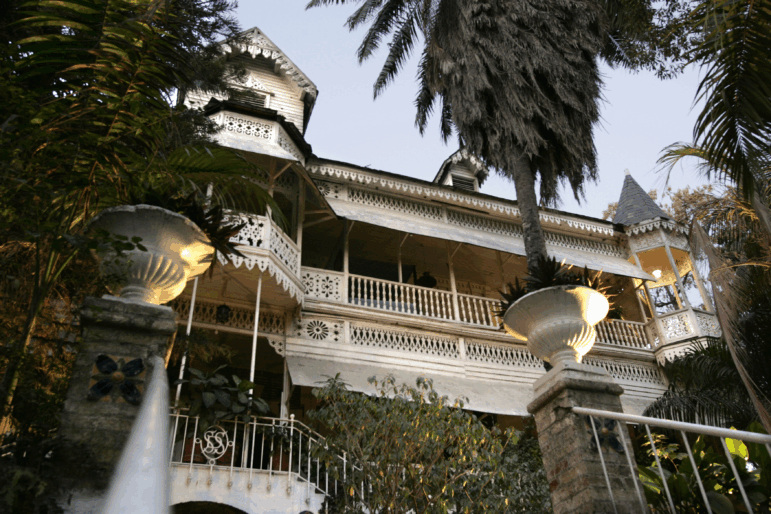 Main entry to the Hotel Oloffson, built as a private residence by Simon Sam in about 1886. American Marines leased it and turned it into a military hospital from 191534. In 1936 Walter Oloffson converted it to a hotel. In the 50's through 70's it was a Hollywood jetset destination.