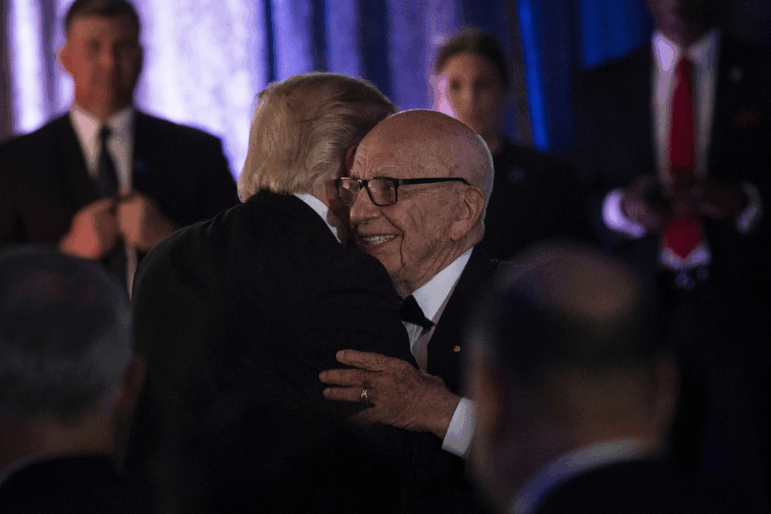 President Trump is embraced by media mogul Rupert Murdoch during a 2017 dinner in New York to commemorate the 75th anniversary of the Battle of the Coral Sea during WWII.