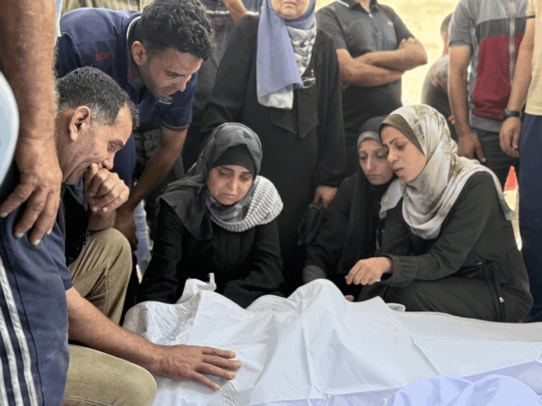 Relatives grieve over bodies of family members killed in an Israeli strike on a school sheltering displaced Palestinians near al-Shifa hospital in Gaza City on Thursday.