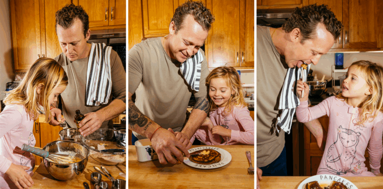 A triptych of photos that shows David Nayfeld making pancakes with his daughter in their kitchen at a wooden island. The first photo shows them putting vanilla extract into a metal mixing bowl. The second photo shows David cutting pancakes on a plate. And the third photo shows his daughter feeding him a bite of pancake.