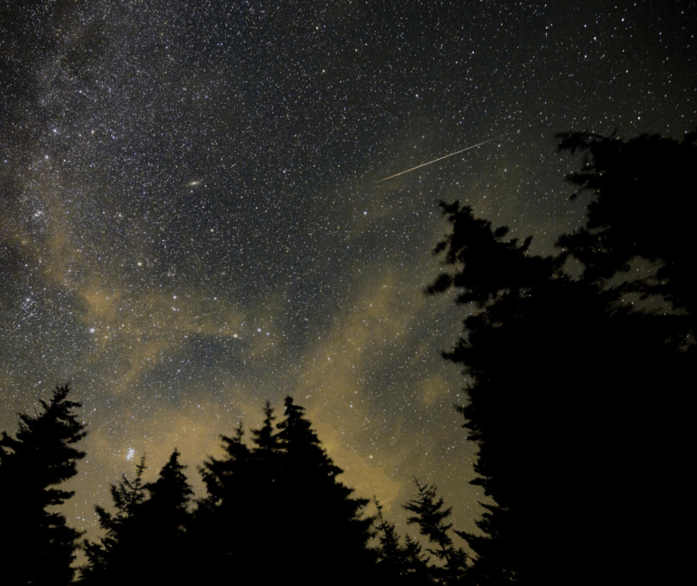 A meteor streaks across the sky during the 2021 Perseid meteor shower.