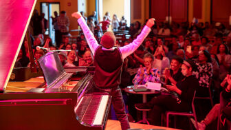 A student at The Ellis Marsalis Center for Music celebrates with the audience after a recital performance in New Orleans on Saturday, Dec. 9, 2023.