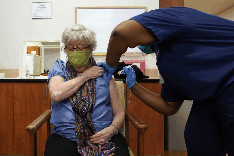 Martha Wilson, of Chapel Hill, gets a COVID-19 vaccine in Pittsboro, N.C at Piedmont Health Senior Care, a federally qualified health center where underserved populations can receive the vaccine.