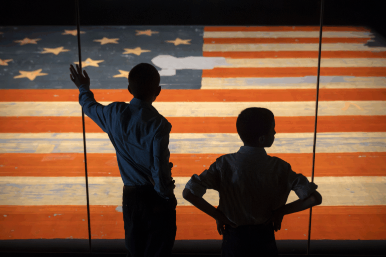 Children look at the Star Spangled Banner, the flag that inspired the lyrics of the American national anthem, at the Smithsonian's National Museum of American History, Tuesday, June 10, 2025, in Washington, D.C.