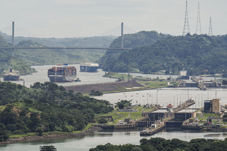A cargo ship navigates through the Panama Canal, seen from the Cerro Ancon in Panama City.