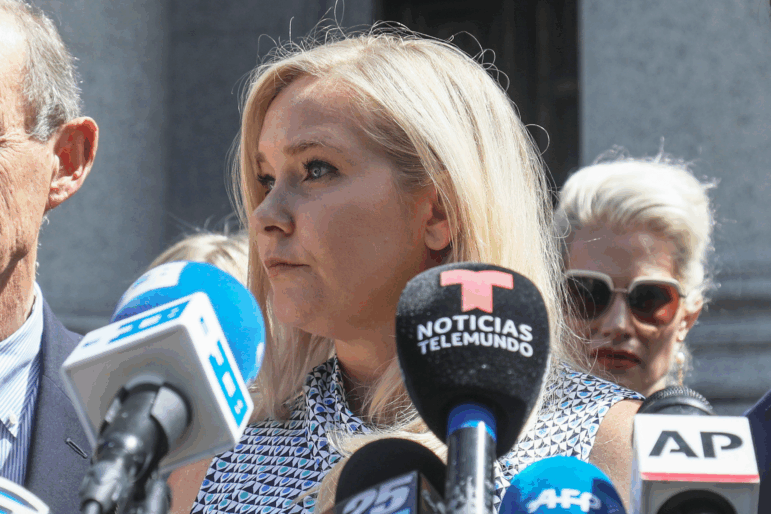Virginia Giuffre, center, holds a news conference outside a Manhattan court in New York, Aug. 27, 2019.