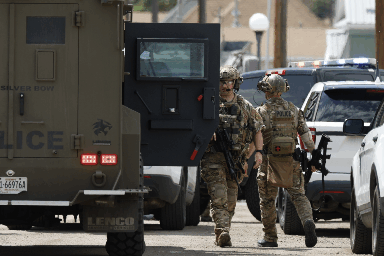 Law enforcement personnel respond to a reported shooting in Anaconda, Mont., on Friday.