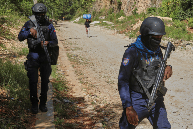 Police officers patrol the area near the Saint-Helene orphanage in the Kenscoff neighborhood of Port-au-Prince, Haiti.