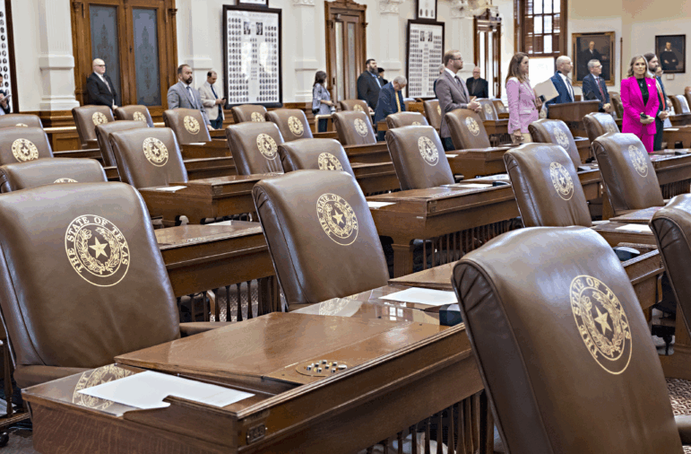 Empty chairs belonging to House Democrats remain empty during a session convocation in the State Capitol, Tuesday, Aug. 5, 2025, in Austin, Texas.